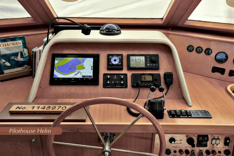 Slide: The Image of 2004 McKinna 57 Pilothouse helm with navigation equipment and controls. - 27
