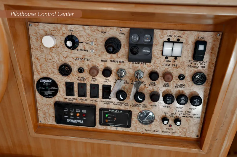 Slide: The Image of 2004 McKinna 57 Pilothouse control panel with various switches and indicators. - 28