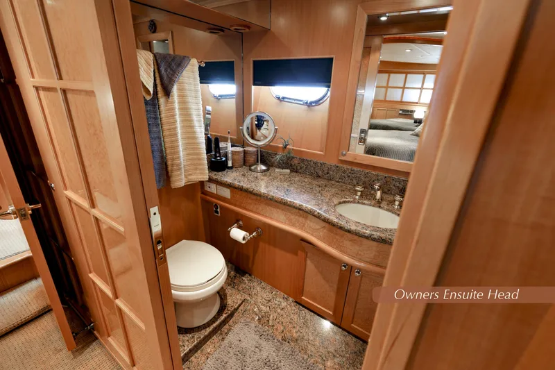Slide: The Image of Luxurious 2004 McKinna 57 Pilothouse owner's ensuite bathroom with elegant wood and granite finishes. - 34