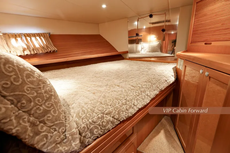 Slide: The Image of Luxurious VIP cabin forward in 2004 McKinna 57 Pilothouse yacht, featuring elegant bedding and wood finishes. - 37