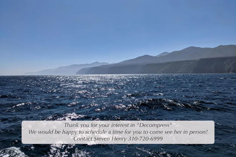 Slide: The Image of Ocean view with mountains, promoting 2004 McKinna 57 Pilothouse yacht "Decompress." Contact for viewing. - 51