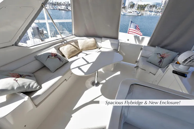 Slide: The Image of 2004 McKinna 57 Pilothouse flybridge with new enclosure and comfortable seating. - 6