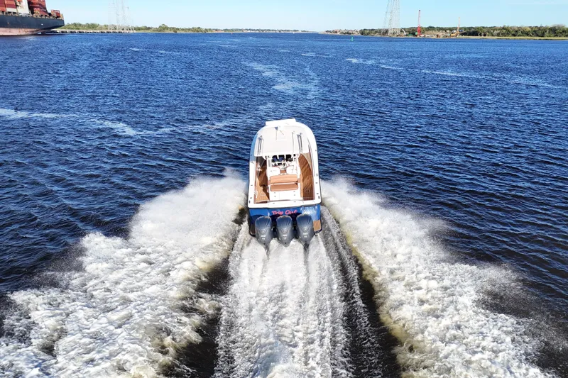 Slide: The Image of 2017 Scout 350 LXF boat cruising on open water, leaving a wake behind. - 35
