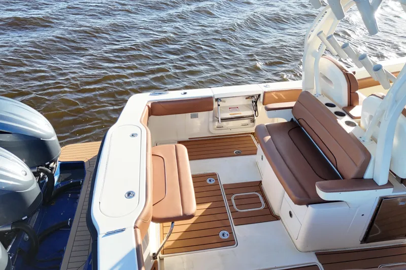 Slide: The Image of 2017 Scout 350 LXF boat interior with brown seating and dual engines on water. - 41
