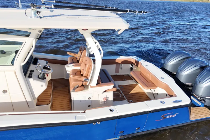 Slide: The Image of 2017 Scout 350 LXF boat with luxurious seating and triple outboard engines on the water. - 42