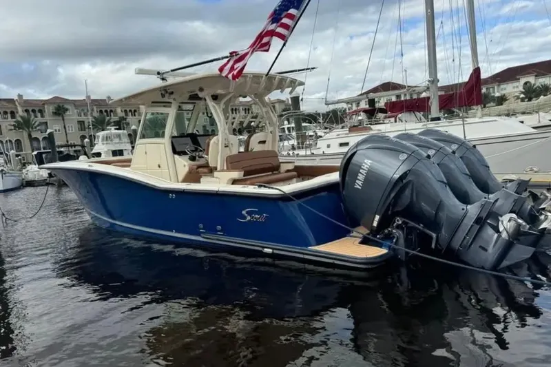 Slide: The Image of 2017 Scout 350 LXF boat with Yamaha engines docked at marina, American flag flying. - 46