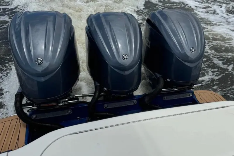 Slide: The Image of 2017 Scout 350 LXF boat with triple Yamaha outboard engines on water. - 48