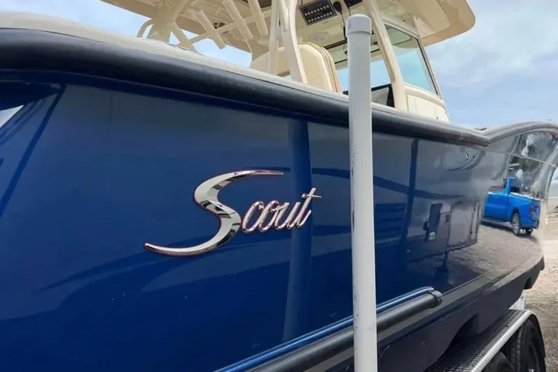 Slide: The Image of 2017 Scout 350 LXF boat with blue hull and elegant logo. - 55