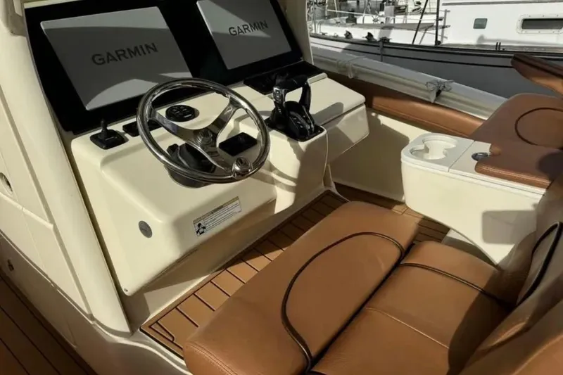 Slide: The Image of 2017 Scout 350 LXF boat cockpit with Garmin displays and leather seating. - 58