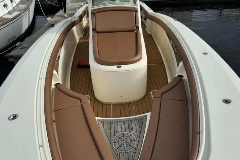 Slide: The Image of 2017 Scout 350 LXF boat interior with brown seating and wood flooring. - 64
