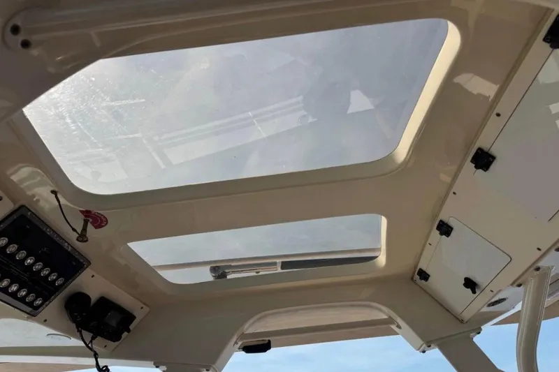 Slide: The Image of 2017 Scout 350 LXF boat interior with skylights and control panel. - 68