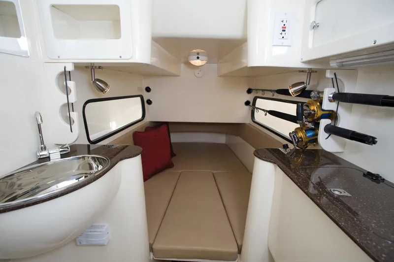 Slide: The Image of Manufacturer Provided Image: 2017 Scout 350 LXF cabin interior with bed, sink, and fishing rod holders. - 70