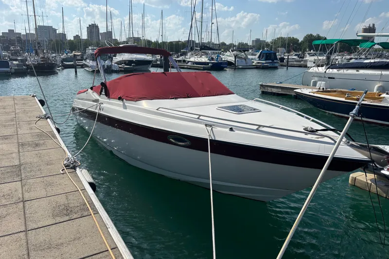 Slide: The Image of 1999 Regal 2850 LSC boat docked in a marina with red cover. - 3