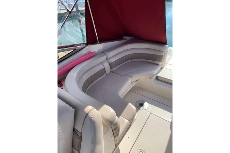 Slide: The Image of 1999 Regal 2850 LSC boat interior with beige seating and red canopy. - 5