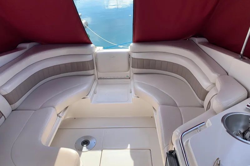 Slide: The Image of 1999 Regal 2850 LSC boat interior with plush seating and maroon canopy. - 6