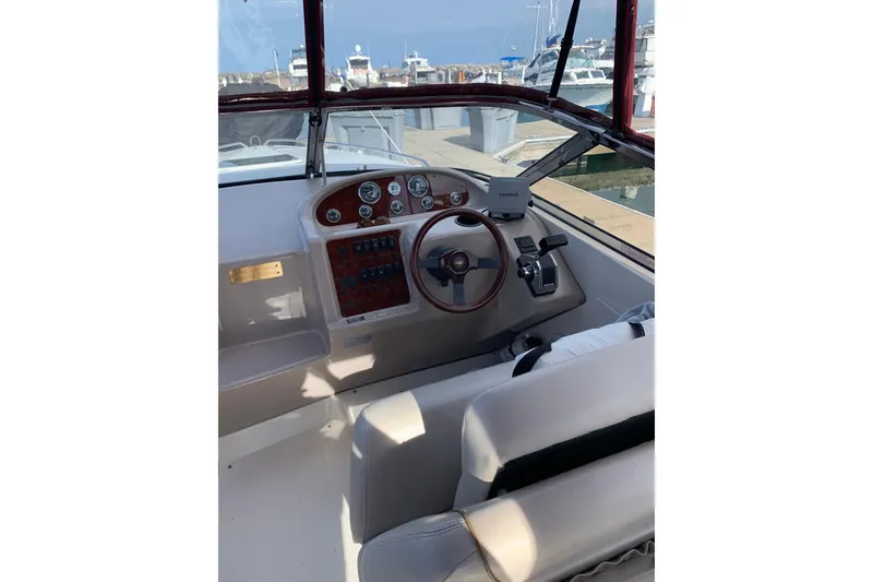 Slide: The Image of 1999 Regal 2850 LSC boat cockpit with steering wheel and dashboard at marina. - 7