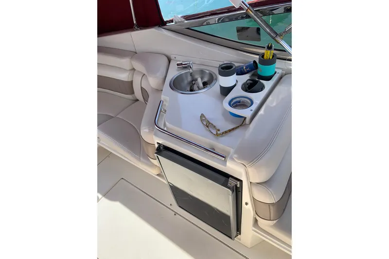 Slide: The Image of Interior of 1999 Regal 2850 LSC boat with seating and mini fridge. - 8