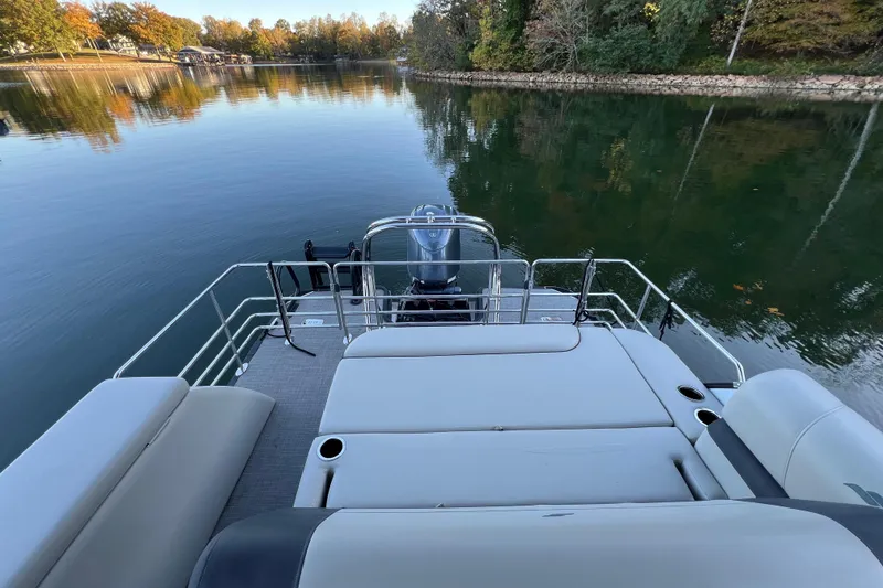 Slide: The Image of 2025 Starcraft EXS 3 Q DH pontoon boat on a serene lake with autumn trees. - 10