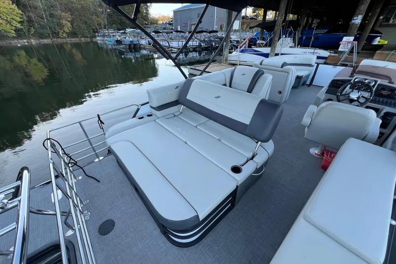 Slide: The Image of Luxurious 2025 Starcraft EXS 3 Q DH boat interior with plush seating and scenic waterfront view. - 12