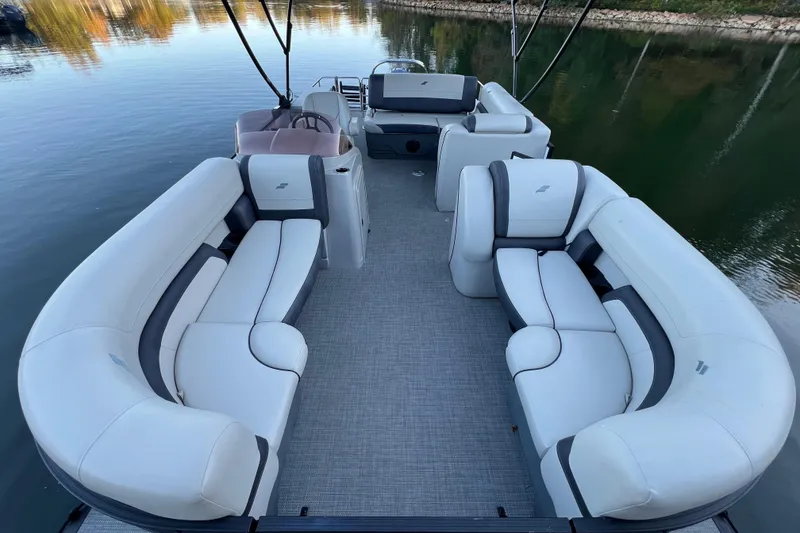 Slide: The Image of 2025 Starcraft EXS 3 Q DH pontoon boat with spacious seating on calm water. - 3