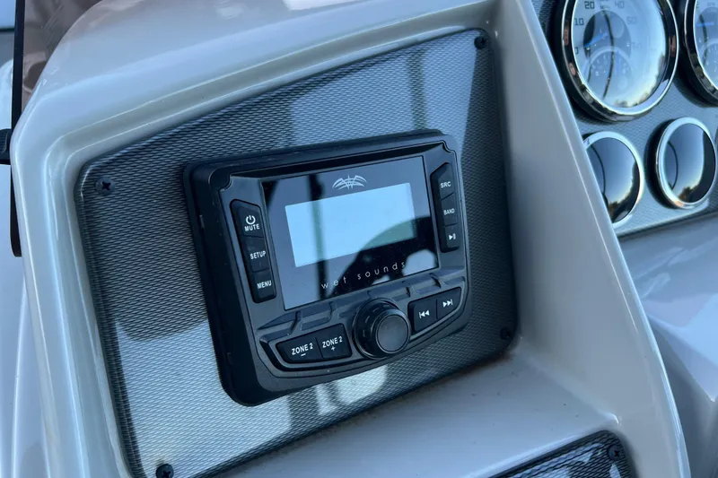 Slide: The Image of Control panel of 2025 Starcraft EXS 3 Q DH boat with audio system and gauges. - 7