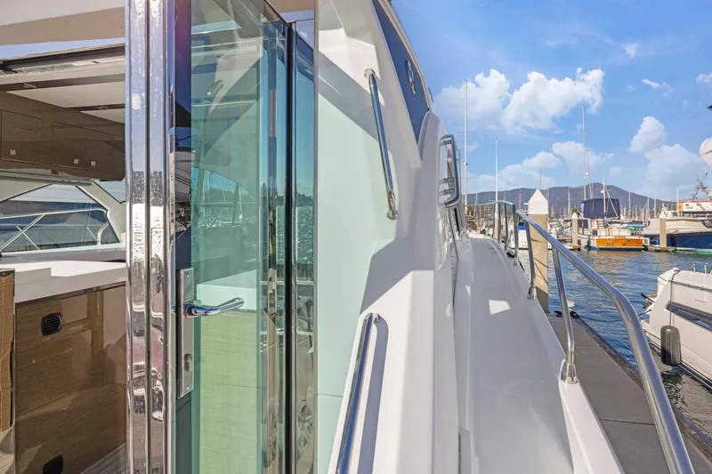 Slide: The Image of 2019 Cruisers Yachts 54 Cantius docked, showcasing sleek design and luxurious interior. - 11