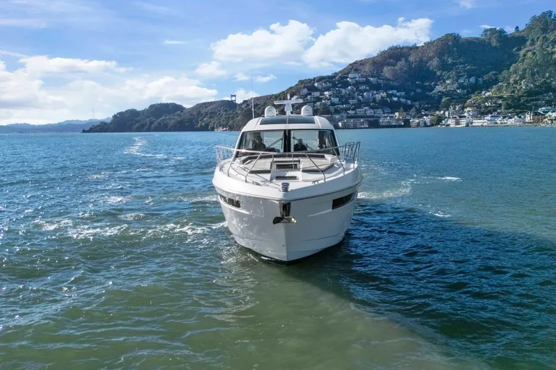 Slide: The Image of 2019 Cruisers Yachts 54 Cantius navigating scenic coastal waters. - 119