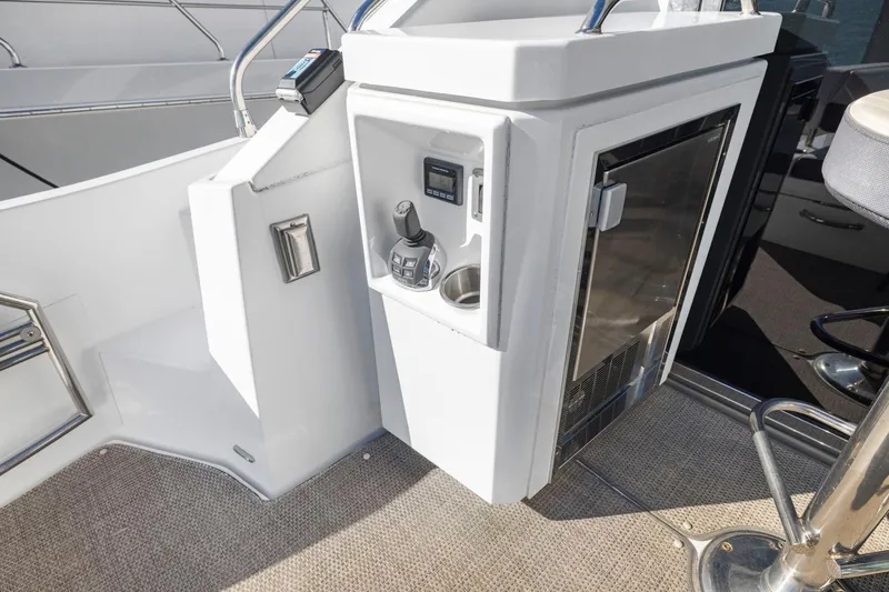 Slide: The Image of 2019 Cruisers Yachts 54 Cantius cockpit with control panel and seating area. - 22
