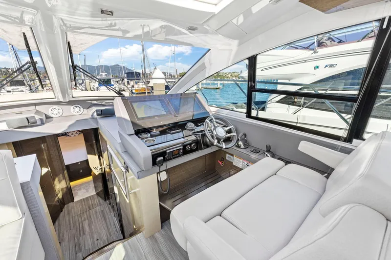 Slide: The Image of Luxurious 2019 Cruisers Yachts 54 Cantius helm with modern controls and plush seating. - 33
