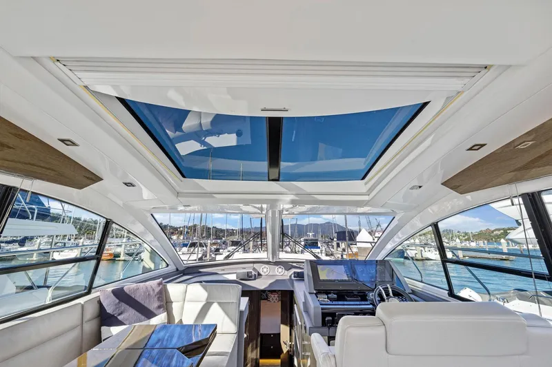 Slide: The Image of Interior view of 2019 Cruisers Yachts 54 Cantius with panoramic windows and modern helm. - 35