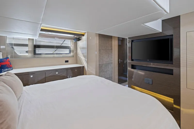 Slide: The Image of Luxurious 2019 Cruisers Yachts 54 Cantius bedroom with modern decor and flat-screen TV. - 64