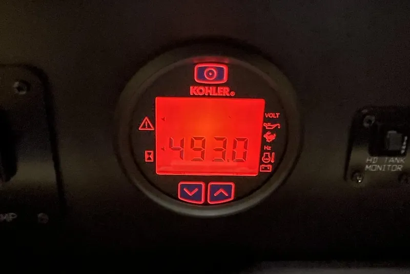 Slide: The Image of Kohler generator display showing 49.3 volts on a 2019 Cruisers Yachts 54 Cantius. - 74