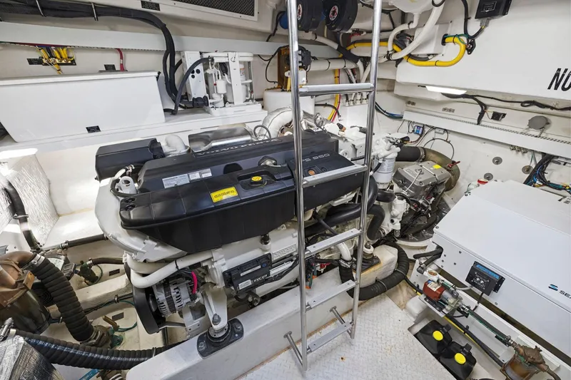 Slide: The Image of Engine room of 2019 Cruisers Yachts 54 Cantius, featuring dual engines and equipment. - 76