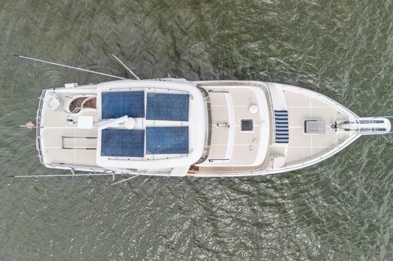 Slide: The Image of Overhead view of 2019 Cruisers Yachts 54 Cantius on water, featuring solar panels. - 79