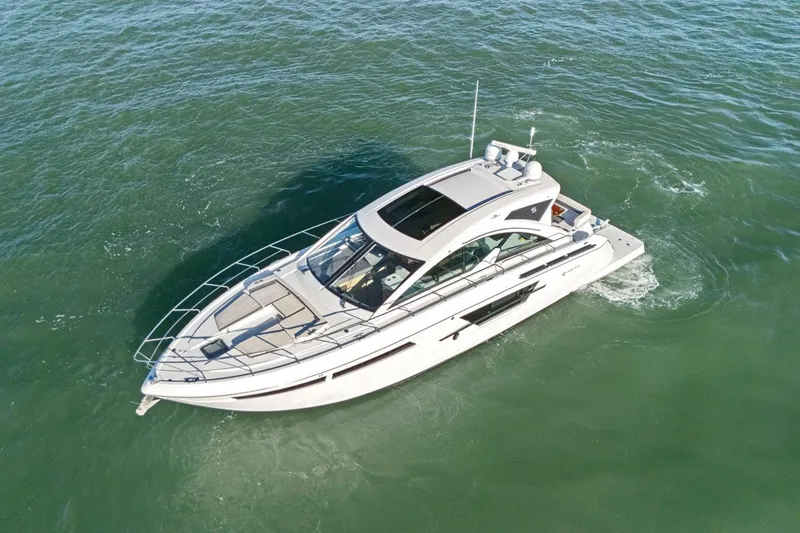 Slide: The Image of 2019 Cruisers Yachts 54 Cantius cruising on open water, aerial view. - 90