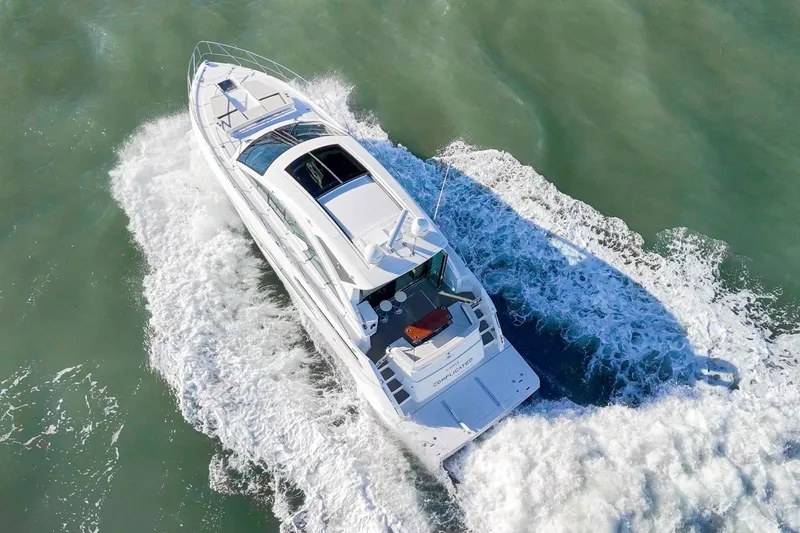 Slide: The Image of 2019 Cruisers Yachts 54 Cantius cruising on open water, aerial view. - 100