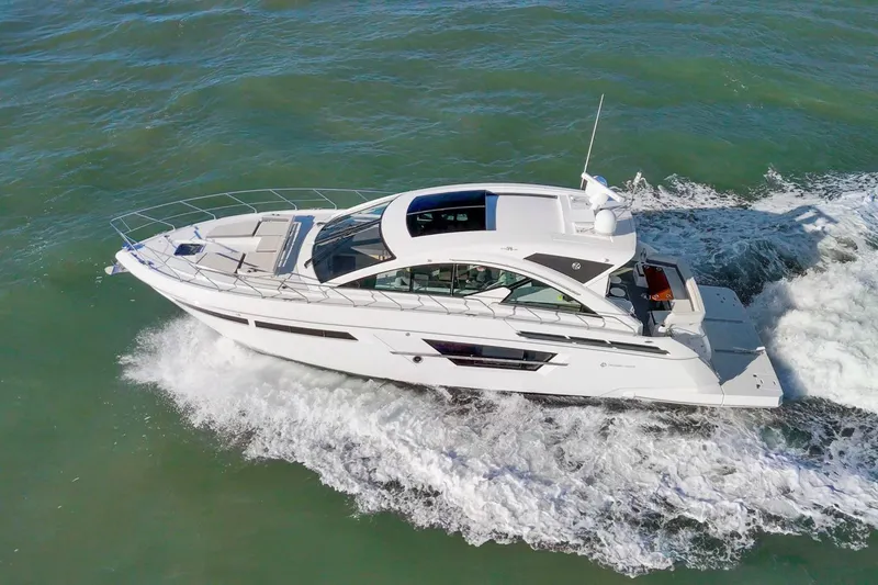 Slide: The Image of 2019 Cruisers Yachts 54 Cantius cruising on open water, showcasing sleek design and luxury. - 101