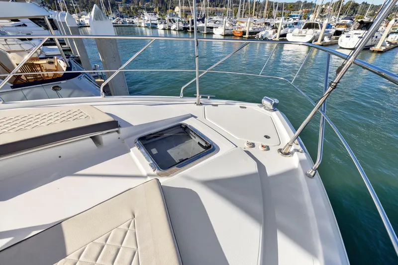 Slide: The Image of Bow view of 2019 Cruisers Yachts 54 Cantius at marina, showcasing deck and railing. - 16