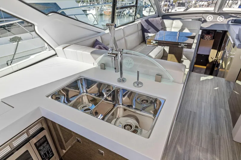 Slide: The Image of Luxurious interior of 2019 Cruisers Yachts 54 Cantius with modern kitchen and seating area. - 28