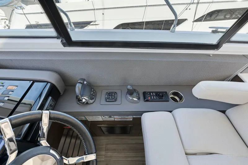 Slide: The Image of 2019 Cruisers Yachts 54 Cantius helm with modern controls and comfortable seating. - 37