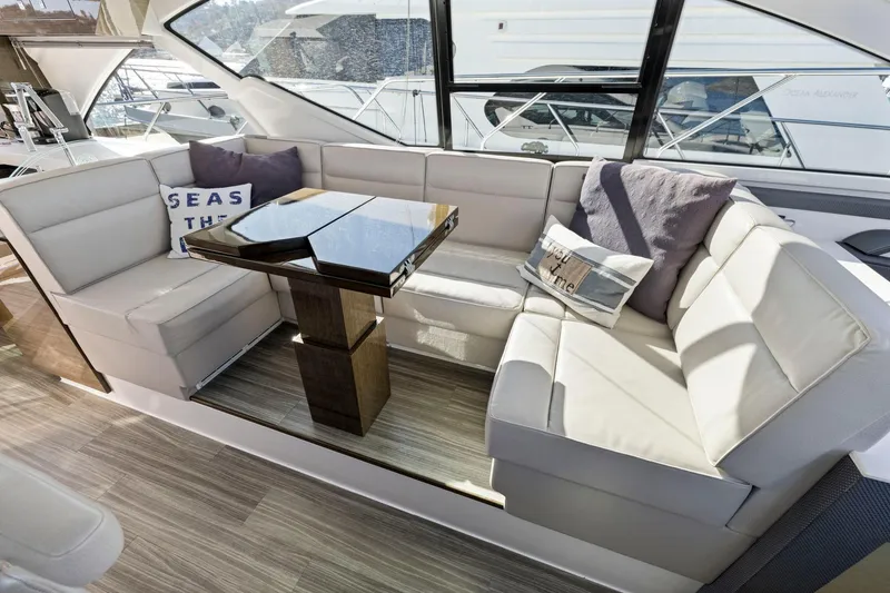 Slide: The Image of Luxurious 2019 Cruisers Yachts 54 Cantius interior with plush seating and elegant table. - 42
