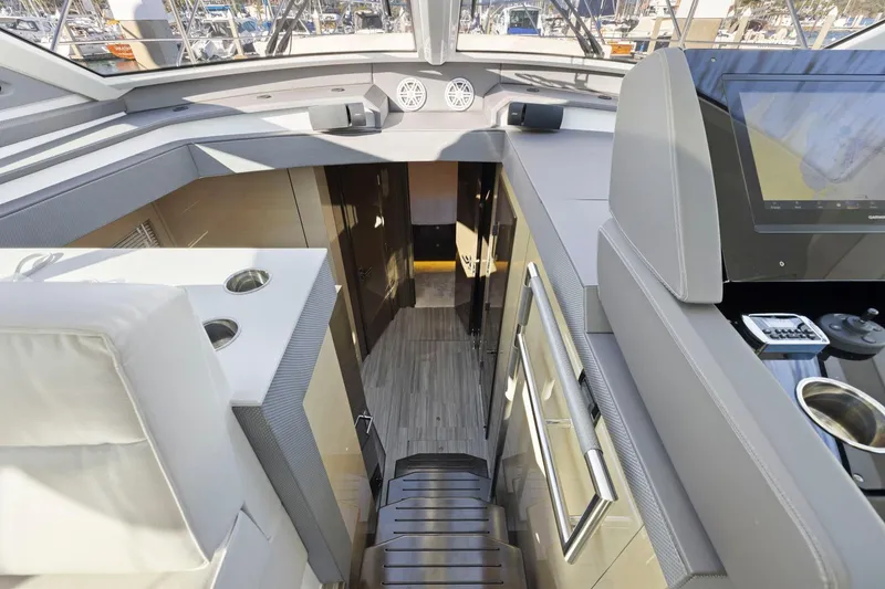Slide: The Image of Interior view of 2019 Cruisers Yachts 54 Cantius, showcasing modern design and navigation equipment. - 45
