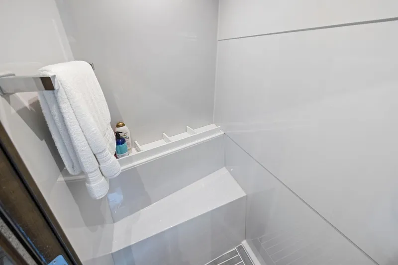 Slide: The Image of Shower area in 2019 Cruisers Yachts 54 Cantius with towels and toiletries. - 54