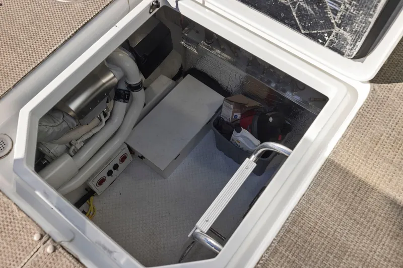 Slide: The Image of Engine compartment of 2019 Cruisers Yachts 54 Cantius, showing pipes and storage. - 71