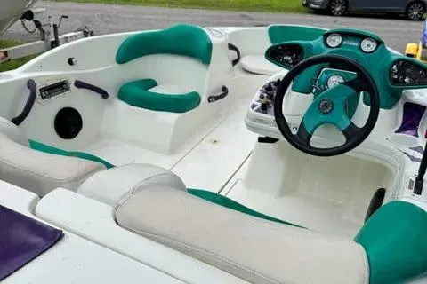 Slide: The Image of 1997 Sea-Doo Switch Sport Compact interior with teal and white seating and dashboard. - 5