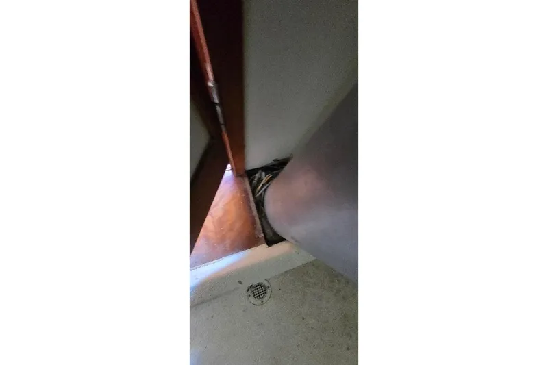 Slide: The Image of Interior view of a 1978 Tartan T34c sailboat, showing a wooden panel and mast base. - 29