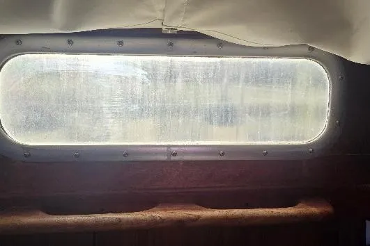 Slide: The Image of Porthole view from 1978 Tartan T34c sailboat, showcasing vintage nautical design. - 54