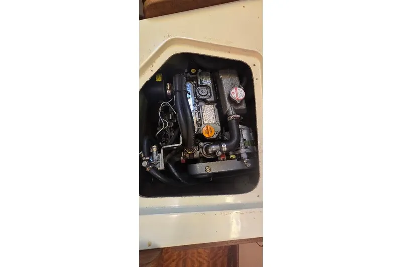 Slide: The Image of 1978 Tartan T34c engine compartment with visible components and hoses. - 59