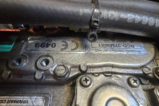 Slide: The Image of Engine close-up of a 1978 Tartan T34c, showcasing metal components and serial numbers. - 61