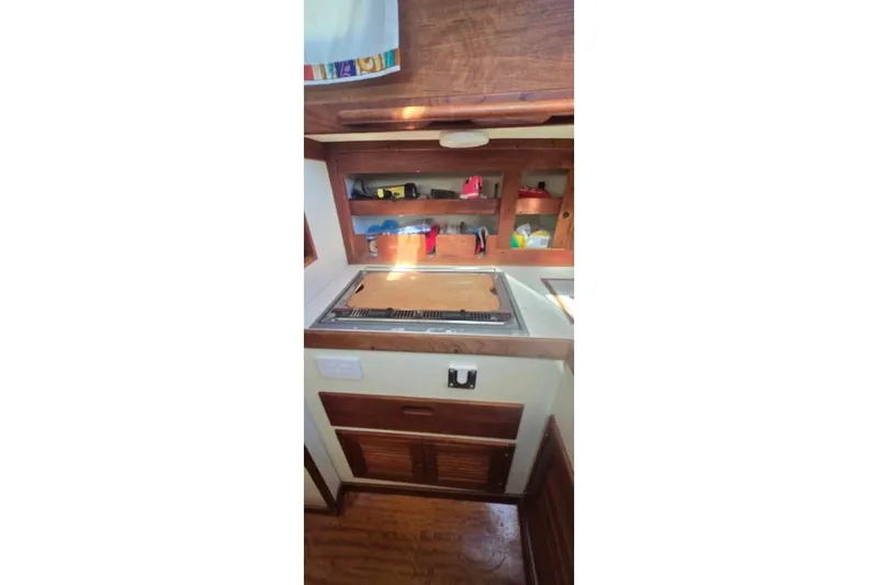 Slide: The Image of 1978 Tartan T34c yacht interior kitchen with wooden cabinets and stove. - 73